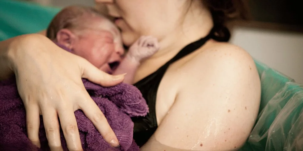 mother giving birth image