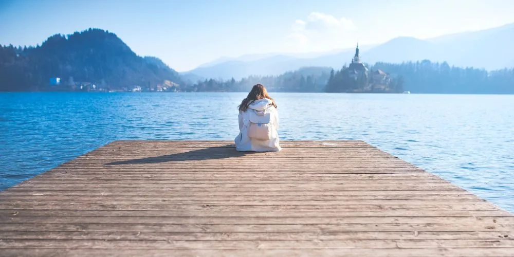 lady at pier thinking image