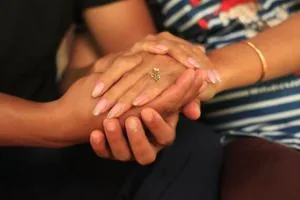 A couple praying while holding hands