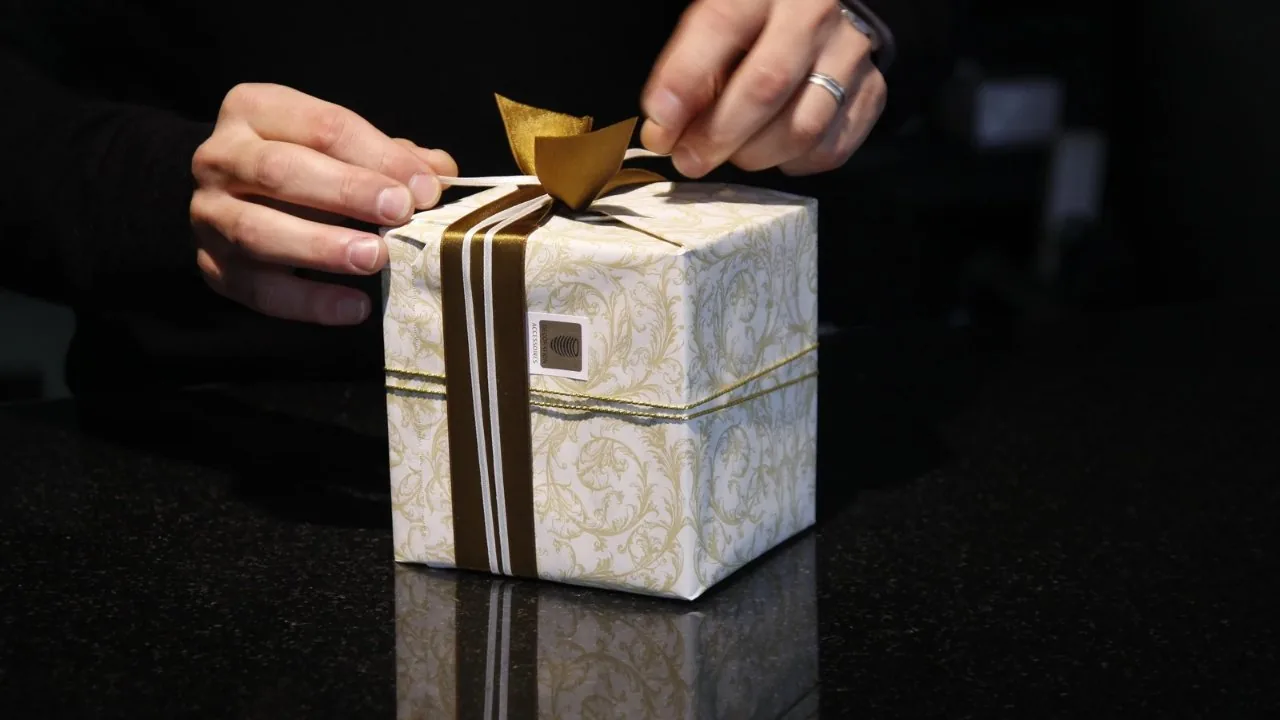 Hands unwrapping a gift