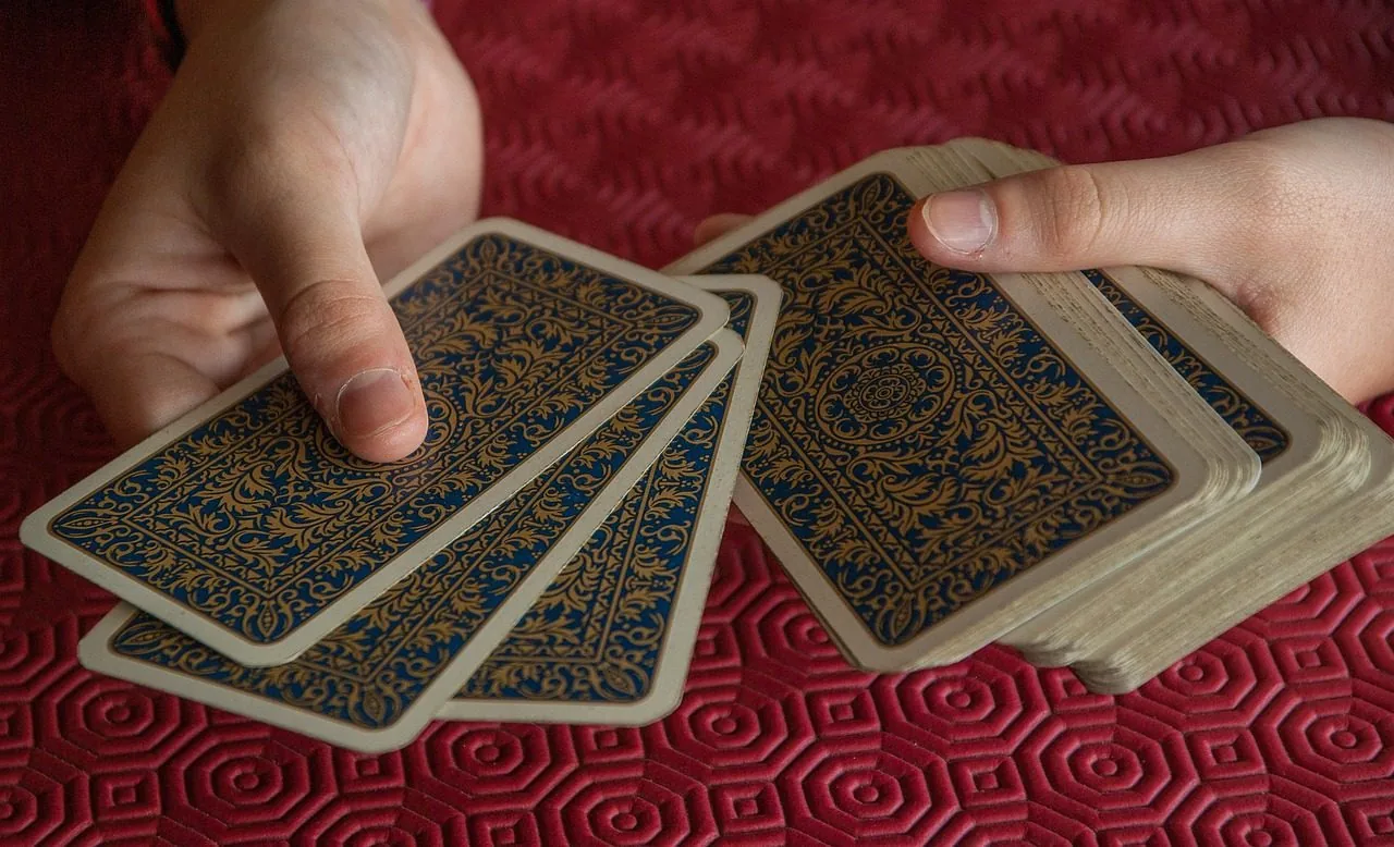 A reader shuffling tarot cards
