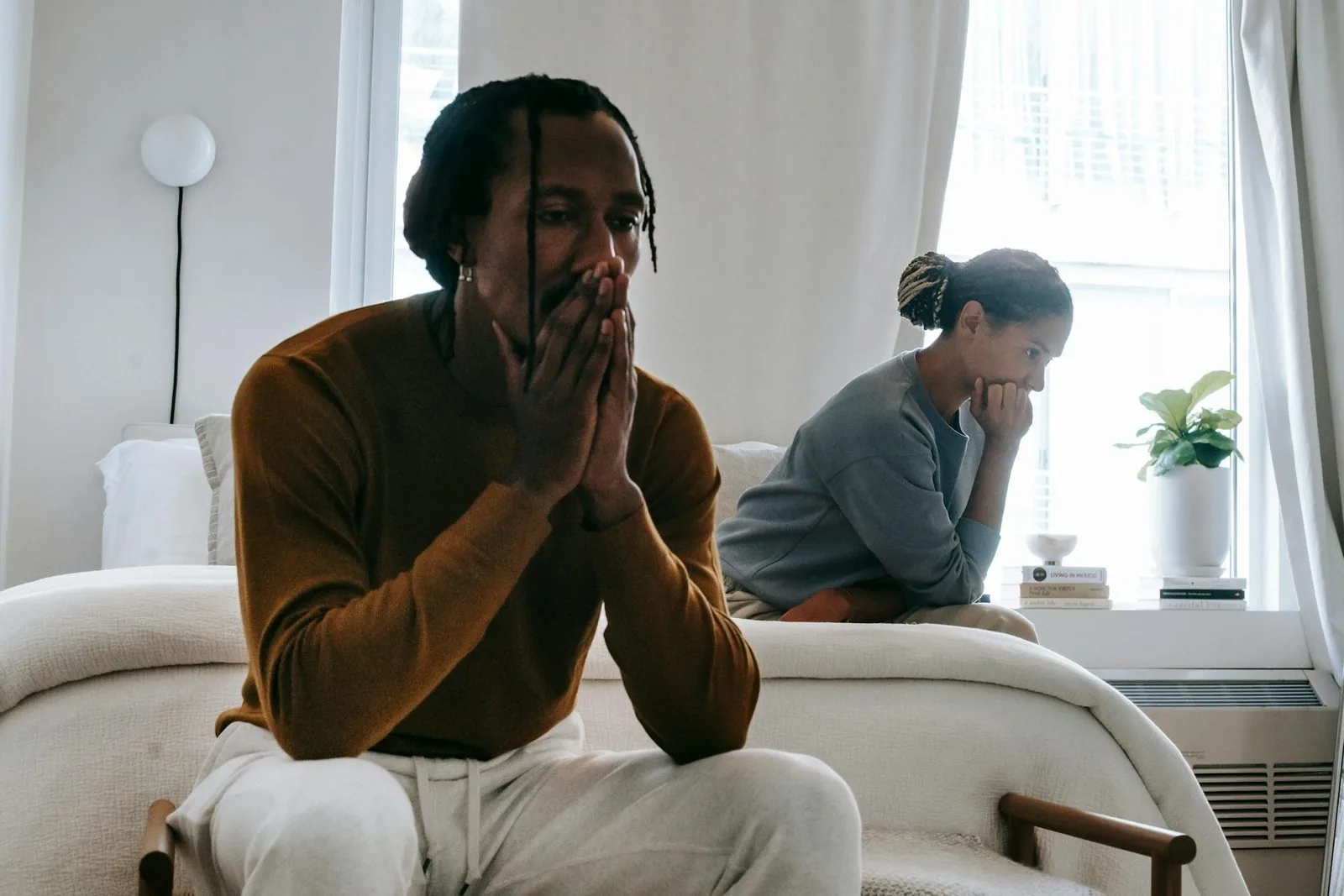 man and woman on the bed arguing