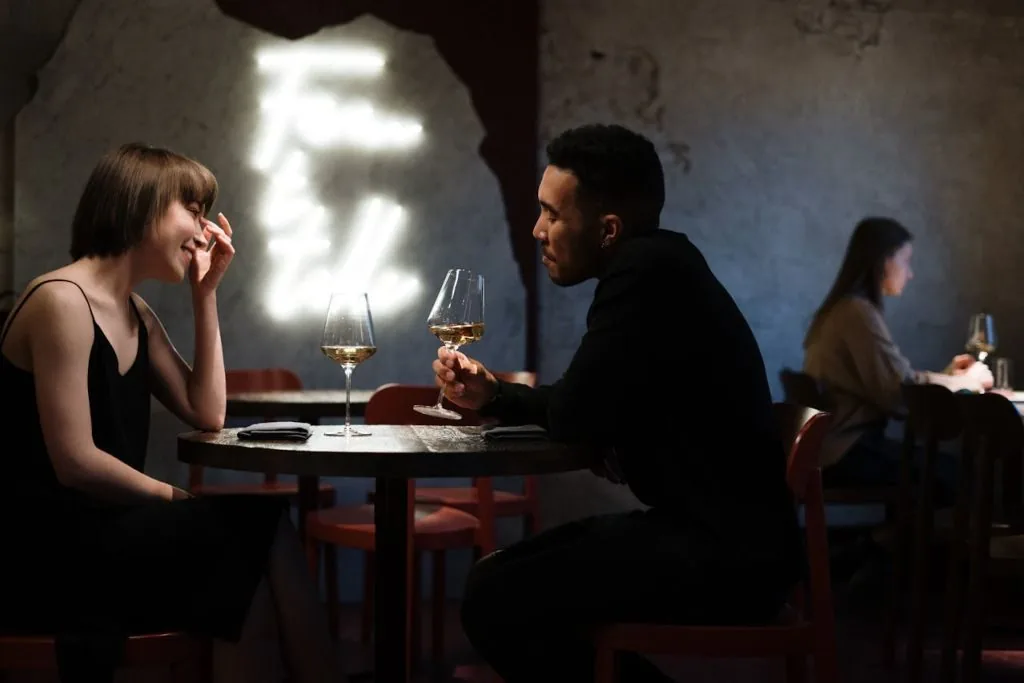 man and woman drinking wine
