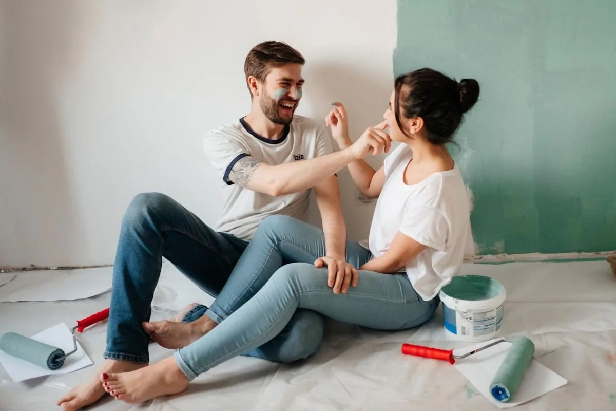 man and woman playing with paint