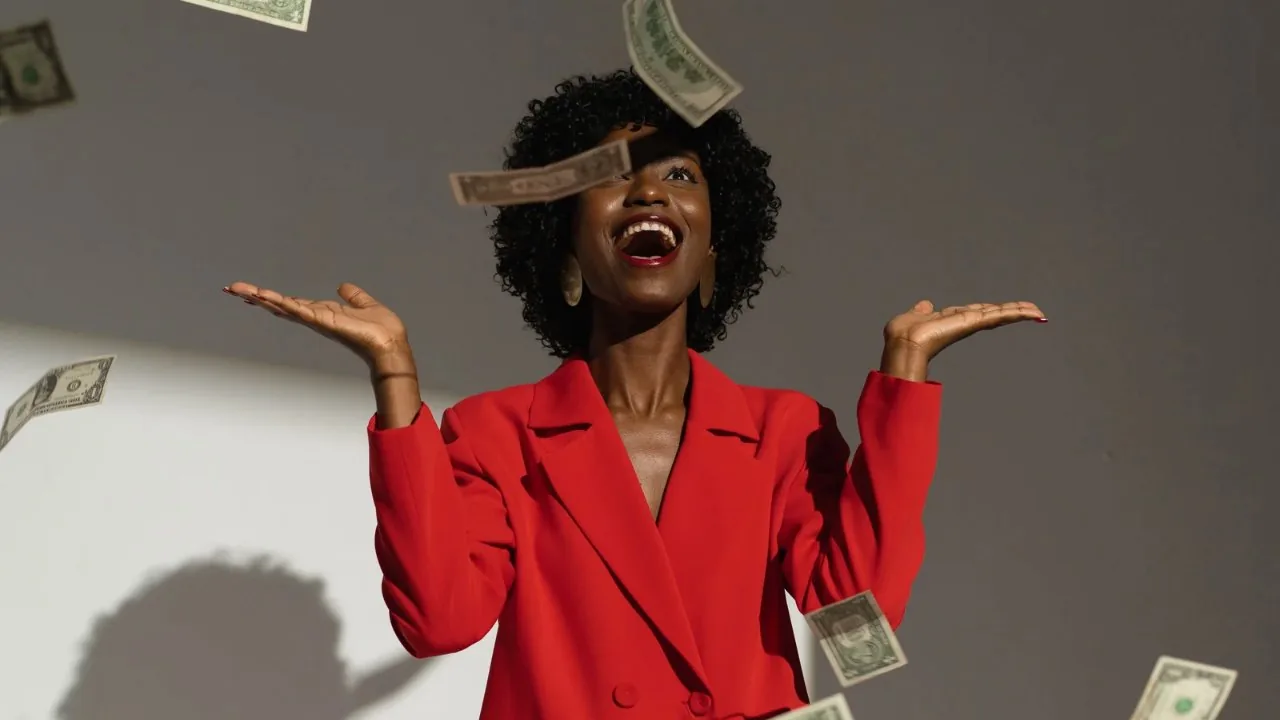 Money shower on a happy lady in red blazer 